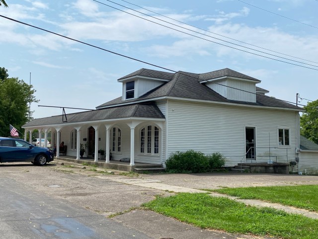 White building, porch pillars, care, grass, road