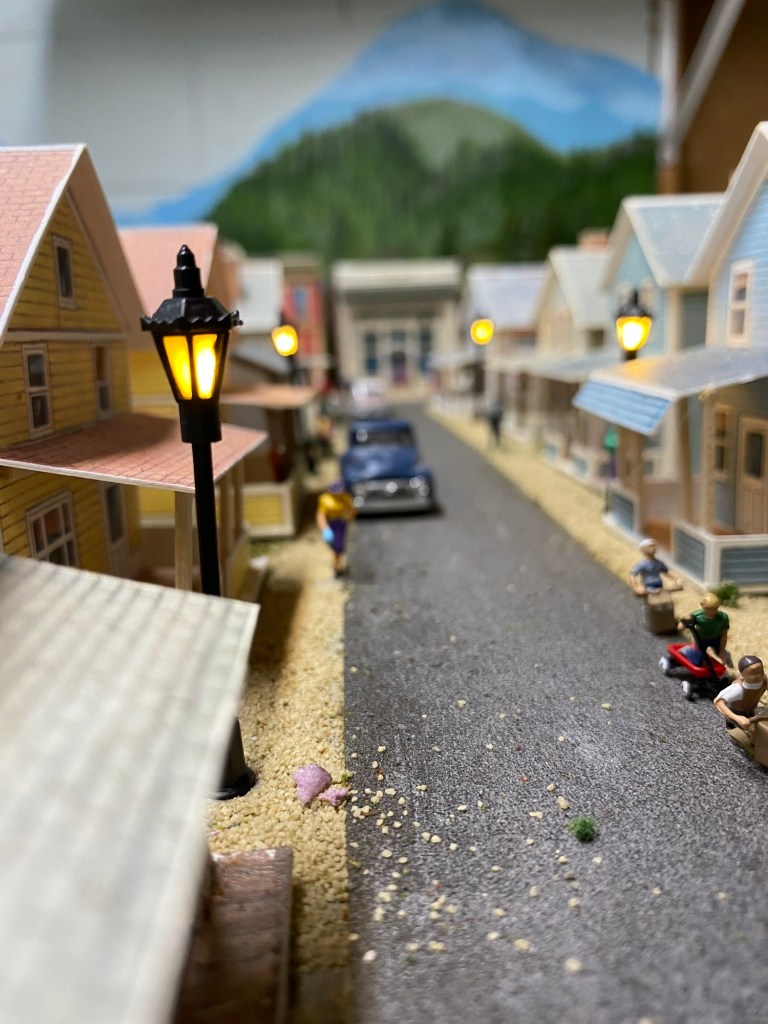 Operating street lights, street, children playing, truck, houses