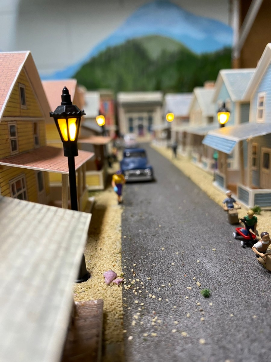 Operating street lights, street, children playing, truck, houses