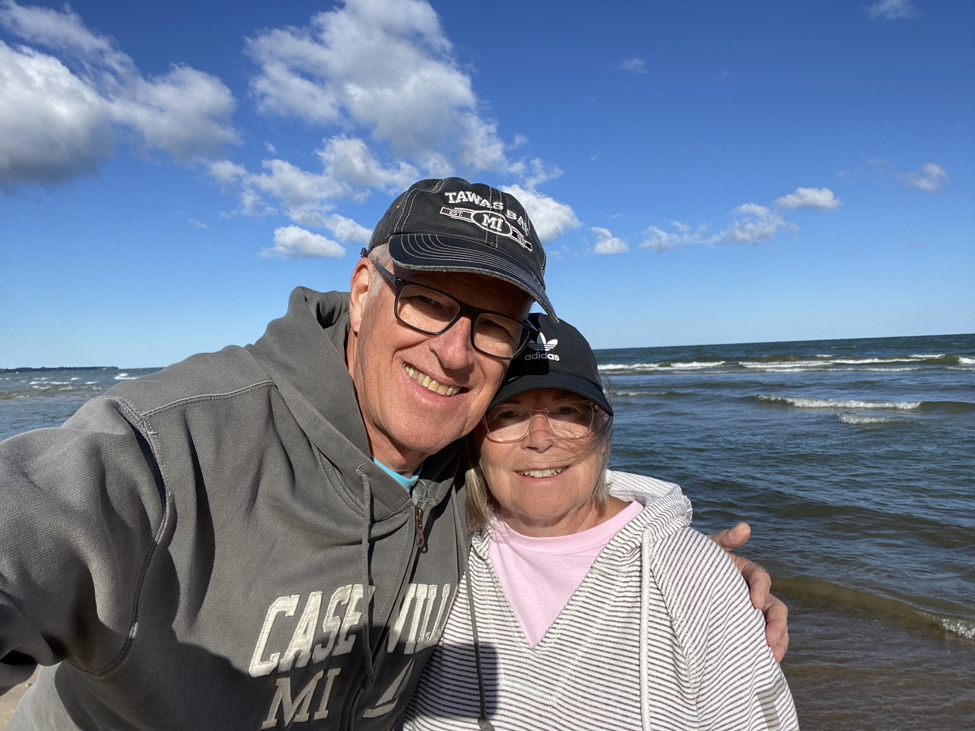Dale & Mary on the beach, blue sky, water, waves