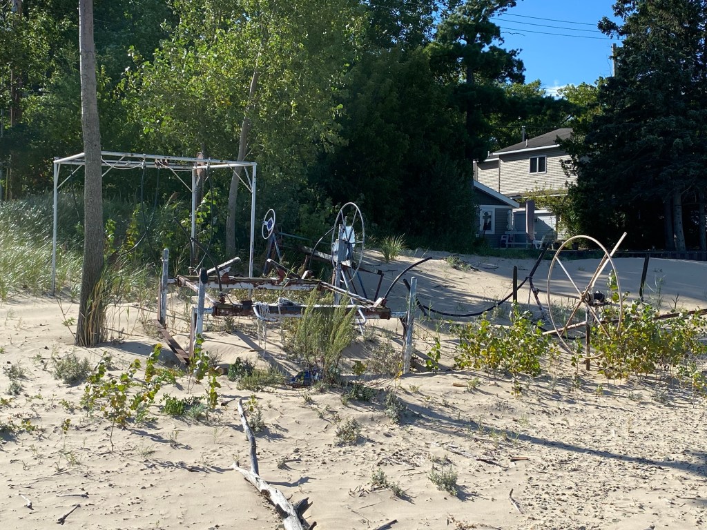 Rusting boat hoists, weeds, trees