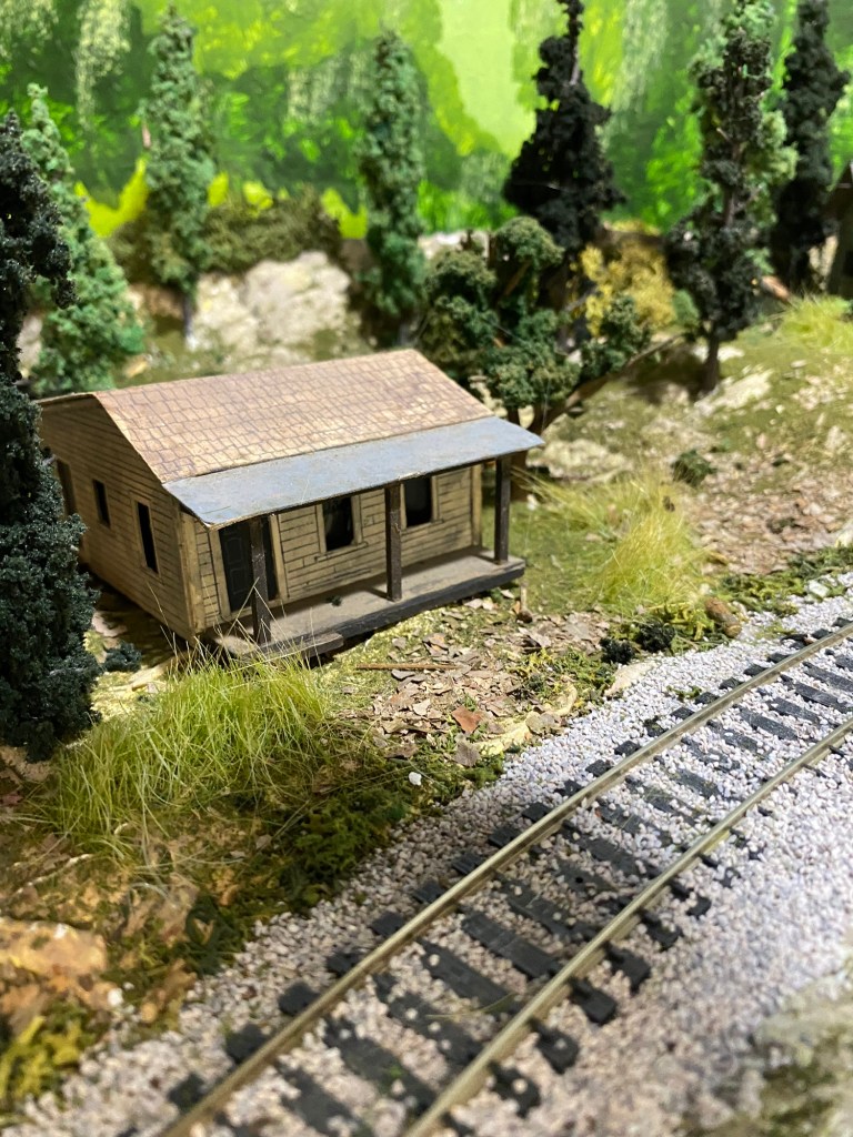 Little Cabin, track, trees, rocks, weeds