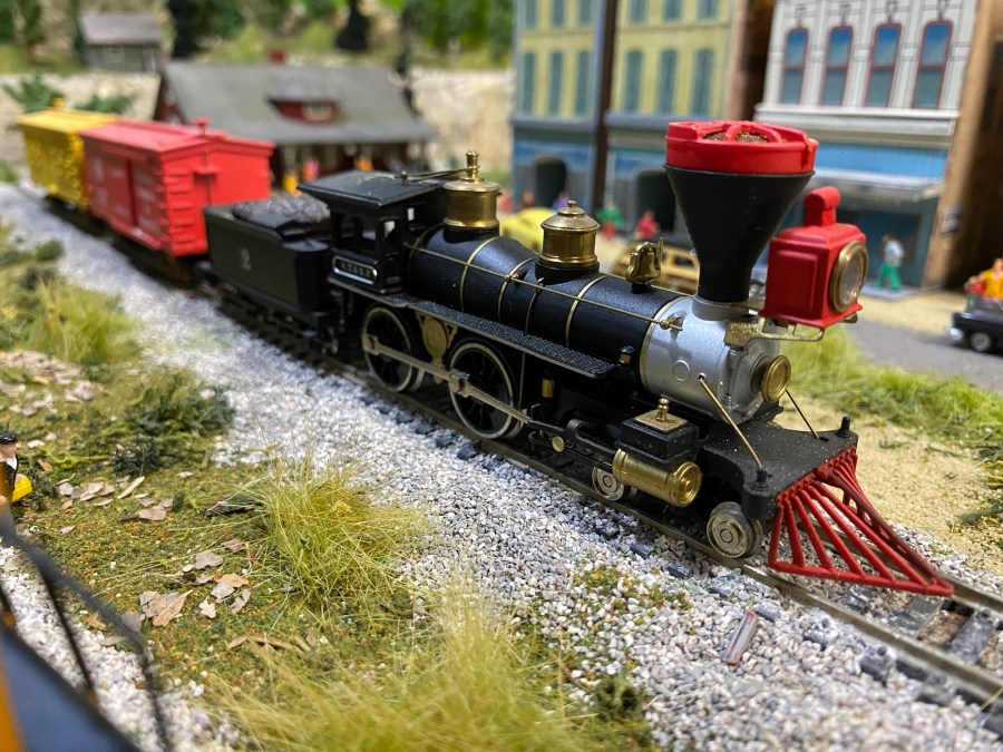 The Old General, two box cars, weeds, cars, buildings