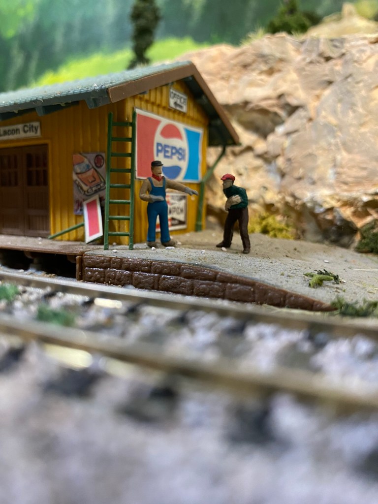 Shed by the tracks, workers, shed