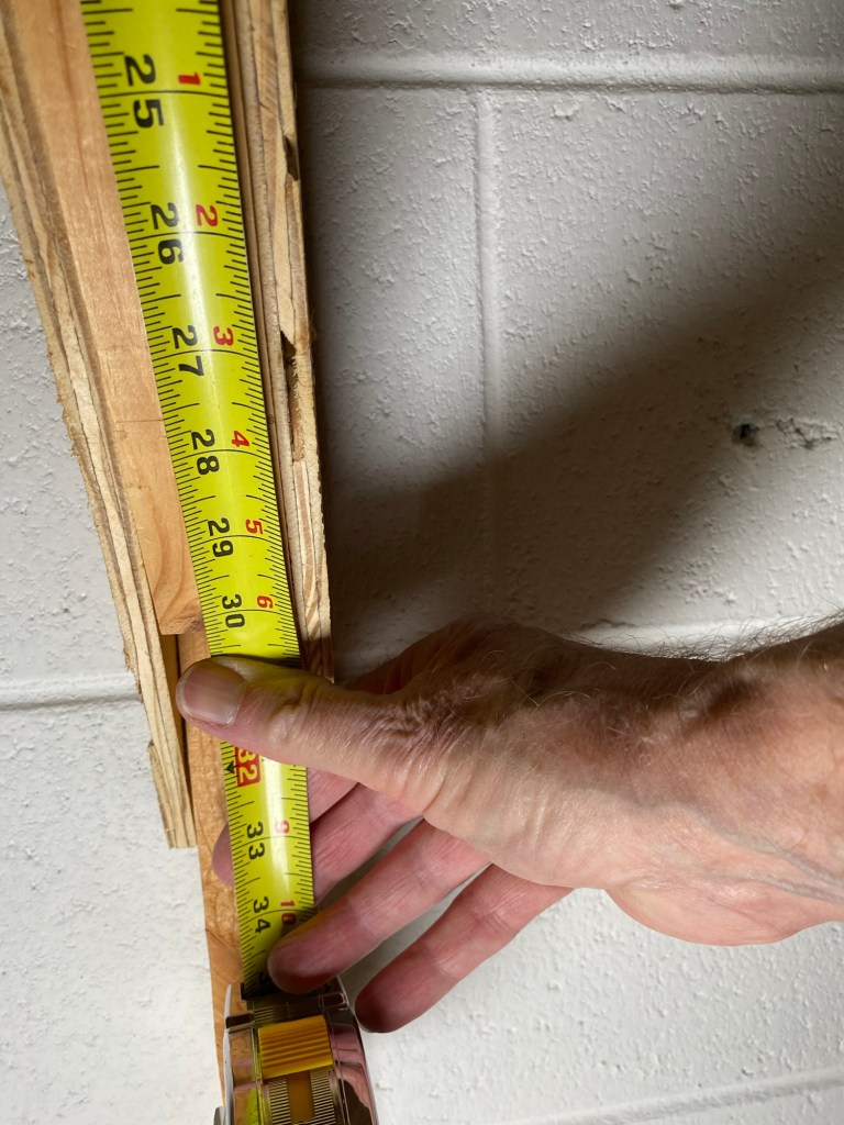 Tape measure showing length of wall bracket to be 30" long.