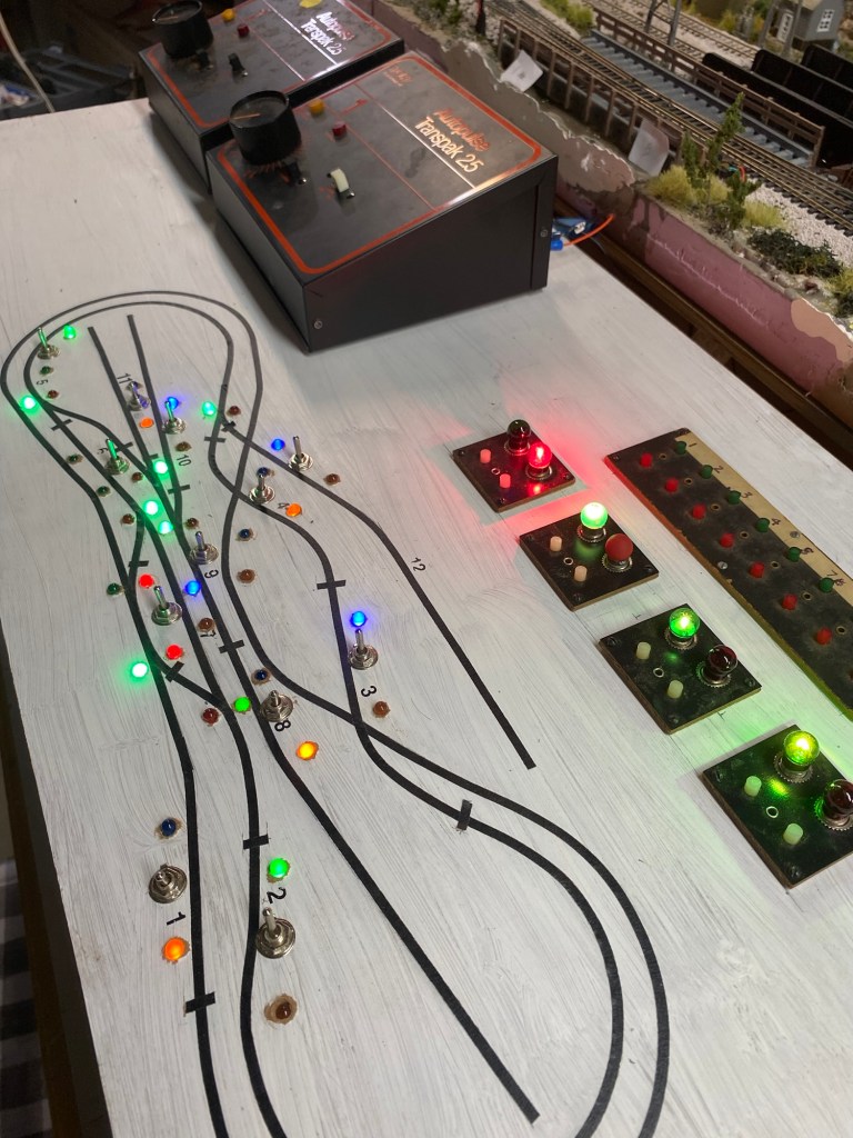 Side view of lighted control panel with two transformers (cabs)