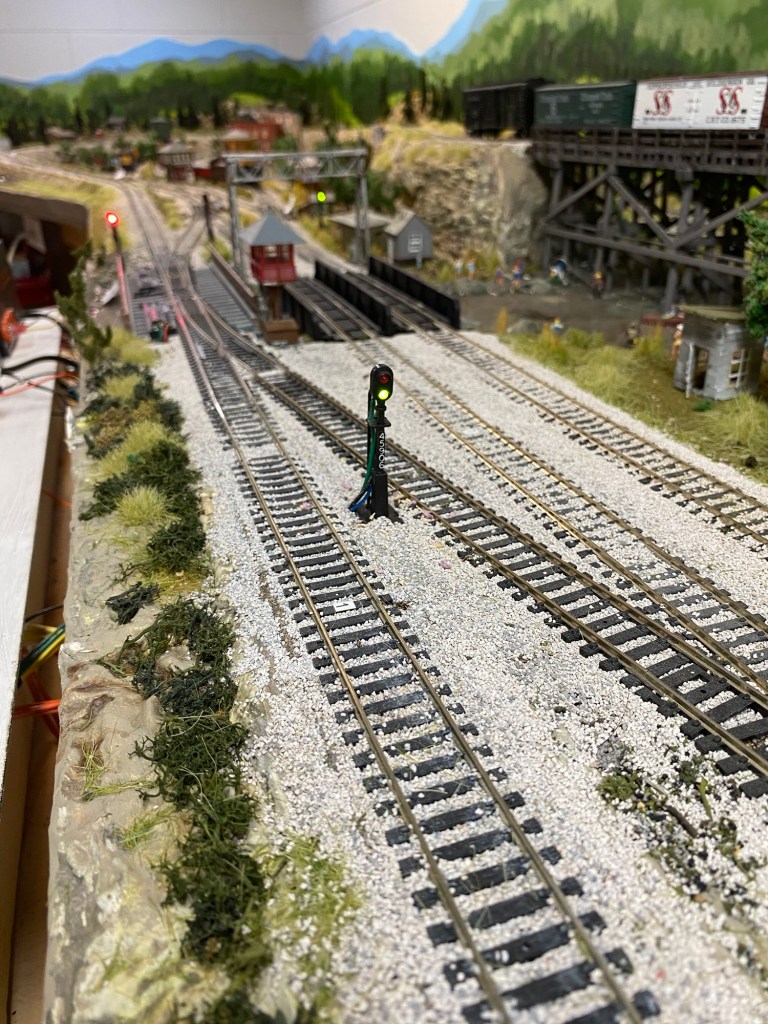 Lighted roadside signals, track, turnouts, trestle, buildings